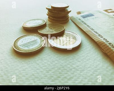 Concept of euro banknotes and coins at white background. European currency. Coins of 1 euro, 2 euro and cents. 50 euro banknotes Stock Photo