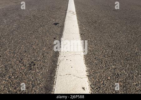 Asphalt road with single solid white line road marking Stock Photo