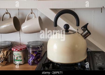 A Camping Tea Kettle On A Propane Stove Next To A Metal Cup Stock Photo,  Picture and Royalty Free Image. Image 42657632.