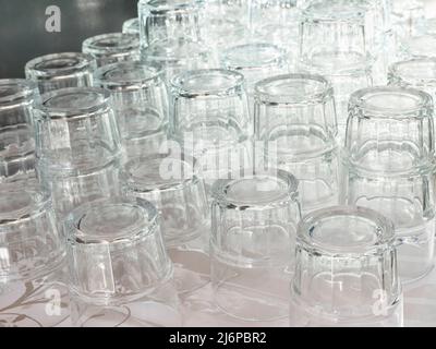 Vertical selective focus shot of glass water pitchers and empty upside-down  glasses on a tray Stock Photo by wirestock