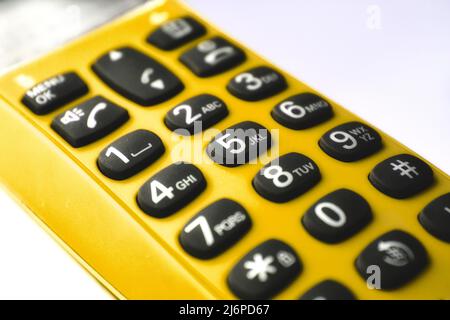 Closeup on keypad of a yellow hand-held phone Stock Photo