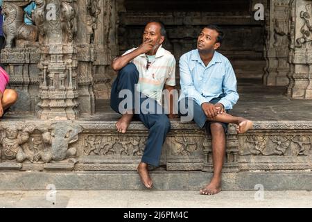 Vellore, Tamil Nadu, India - September 2018: Two Indian men sitting in the ancient Hindu temple at the Vellore Fort. Stock Photo