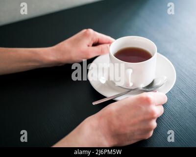 morning Cup of tea in the hands of a young woman Stock Photo