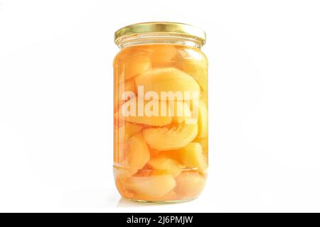 Canned peaches in glass jar isolated on white background. Compote made of sliced fruit halves Stock Photo
