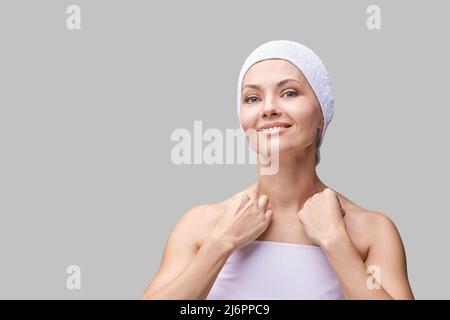 Pure skin care mature beauty portrait. Self massage. Cosmetology plastic foundation. Anti wrinkle senior cream. Elegant Hands near female head. Medical treatment clinic. Woman nature makeup. Stock Photo