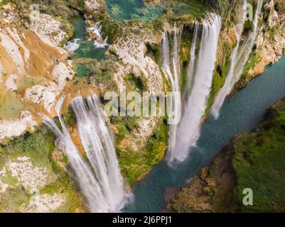 Aerial view of Beautiful Fascinating Tamul Waterfall with turquoise water in San Luis Potosi, Mexico