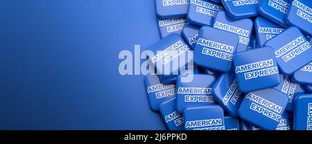 Logos of the payment card services company American Express on a heap on a table. Copy space. Web banner format. Stock Photo