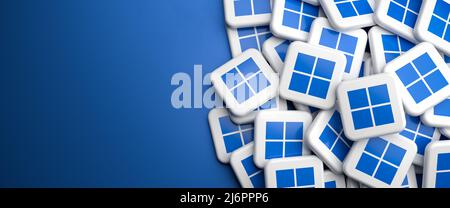 Logos of the PC operating system Windows on a heap on a table. Copy space. Web banner format. Stock Photo