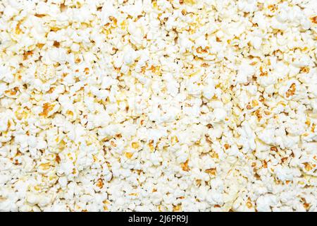 Popcorn texture background. Scattered salted popcorn. Food background. Stock Photo