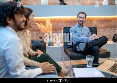 Experienced psychotherapist consulting a couple in his office Stock Photo