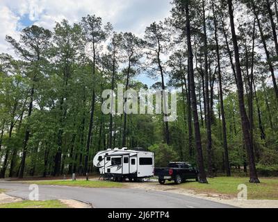 A fifth wheel RV travel trailer set up for camping at the Santee State Park in South Carolina, USA. Stock Photo