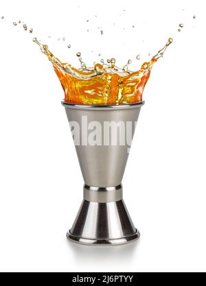 orange liquor spilling out of a jigger isolated on white background Stock Photo