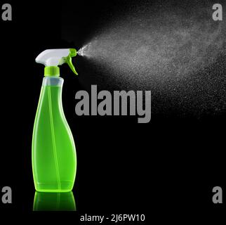 detergent spraying fluid isolated on black background Stock Photo