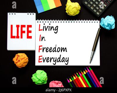 LIFE living in freedom everyday symbol. Concept words LIFE living in freedom everyday on beautiful black background. Black calculator. Business LIFE l Stock Photo