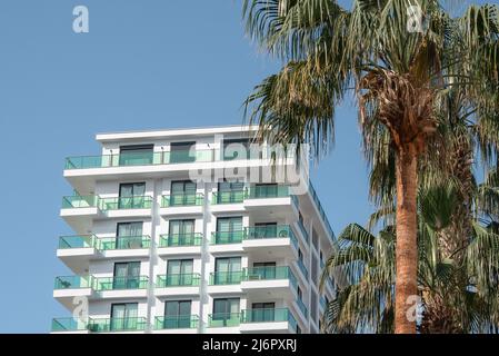 View of a part of a newly built residential building in southern Turkey. Windows and balconies Stock Photo