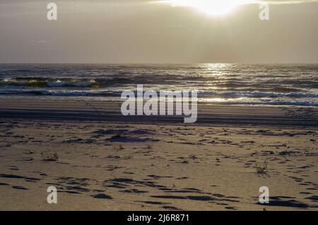 Reflection of sunlight in the sea waves. The sky in the sunset rays. Baltic Sea. Sunset over the sea. Stock Photo