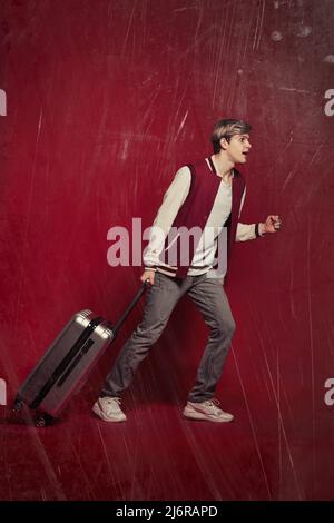 Young excited caucasian man tourist with suitcase Stock Photo