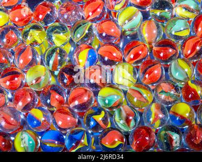 fun game for kids with colored glass marbles, glass balls Stock Photo -  Alamy