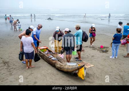 Local People Selling Fresh Fish From Their Caballitos De Totora (Traditional Reed Boats), Pimentel Beach, Chiclayo, Chiclayo Province, Peru. Stock Photo