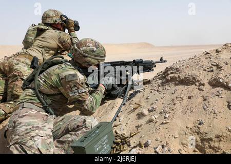 CAMP BUEHRING, Kuwait-U.S. Soldiers assigned to the 3-157th Field Artillery Regiment fire a M-240B at the range during the U.S. Army Central Best Squad Competition. BSC 2022 measures the abilities of squads to perform physical and mental challenges as a cohesive team. (U.S. Army photo by Spc. William China, U.S. Army Central Public Affairs) Stock Photo