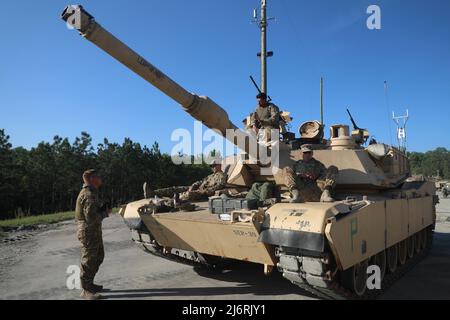 The M1A2 SEP V2 main battle tank crew assigned to 2nd Battalion, 69th Armor Regiment, 2nd Armored Brigade Combat Team, 3rd Infantry Division, waits to begin boresight operations during the Sullivan Cup at Fort Benning, Georgia, May 3, 2022. The Sullivan Cup highlights and validates training education required to employ the latest advancements of Armor modernization in support of Armored Brigade Combat Teams and Cavalry formations. (U.S. Army Photo by Pfc. Duke Edwards, 50th Public Affairs Detachment) Stock Photo