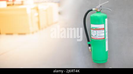 Fire extinguishers hanging on the wall are available in fire emergencies at the department store. Stock Photo