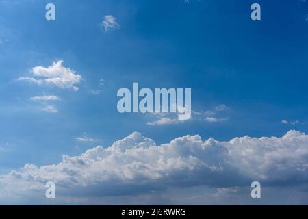 White cumulus clouds floating in the blue sky Stock Photo