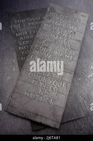 The Ten Commandments Carved into Two Black Slate Stones Stock Photo