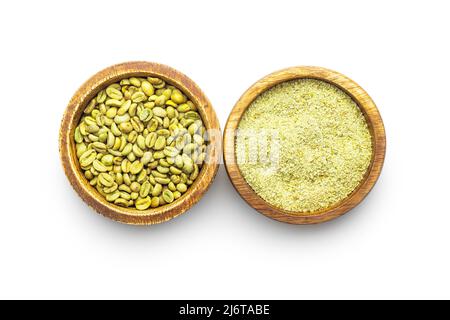 Ground green coffee and coffee beans in bowl. Unroasted coffee isolated on a white background. Stock Photo