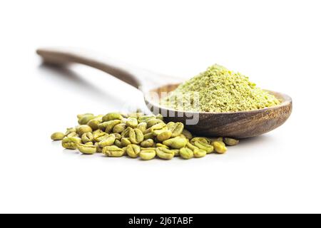 Ground green coffee and coffee beans in wooden spoon. Unroasted coffee isolated on a white background. Stock Photo
