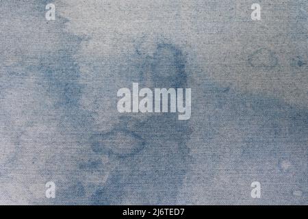 Close up of white fabric texture with blue stains creating abstract design Stock Photo