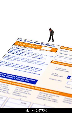 Miniature scale model businessman with a P60 End of year Certificate issued by HMRC in the United Kingdom.  Blank tax form Stock Photo