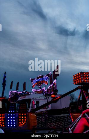 The blue and red lights of the Jetfire funfair ride brighten the night ...
