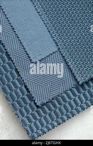 The background consists of several types of old colored tiles with different patterns on blue tone Stock Photo