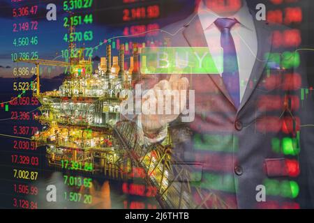 The business man using modern visual technology for trading to sell in oil and gas stock market with index graph and indicator background, Investment Stock Photo
