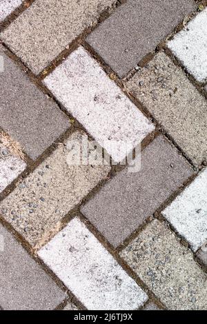 Closeup of sidewalk paved with rectangular white and gray tiles in top view. Stock Photo
