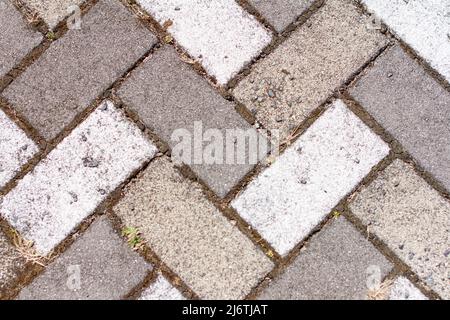Closeup of sidewalk paved with rectangular white and gray tiles in top view. Stock Photo