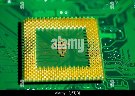 Macro Close up of microchips and pins on Main CPU PC processor circuit board. Stock Photo