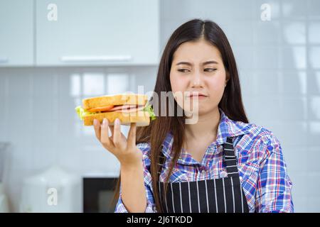 asian woman unhappy make sandwich. Stock Photo