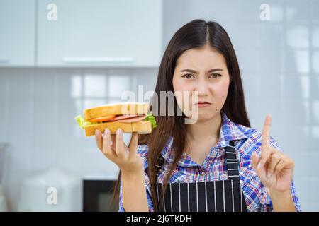 asian woman unhappy make sandwich. Stock Photo