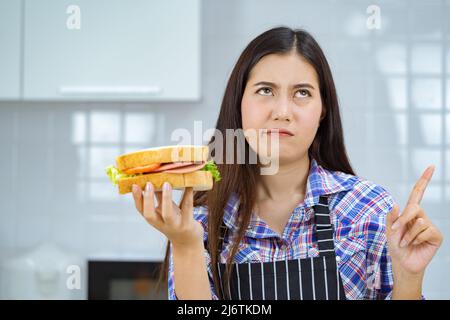 asian woman unhappy make sandwich. Stock Photo