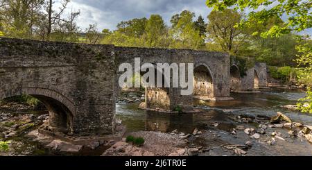 The picturesque Llangynidr Bridge that arches over the River Usk at Llangynidr, Powys, Brecon Beacons, Wales. Stock Photo