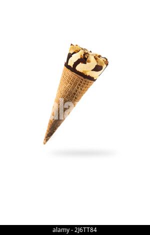 Vanilla and chocolate ice cream cone floating in the air isolated on white background Stock Photo