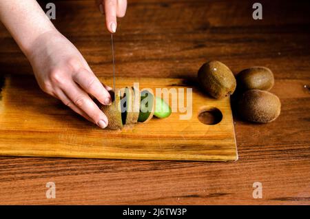 Sliced kiwi on a wooden board Stock Photo