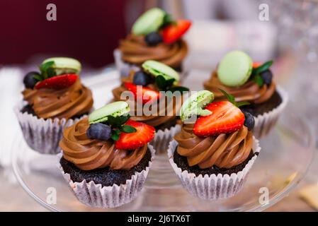 Multi-colored cakes and sweets on the festive table Stock Photo