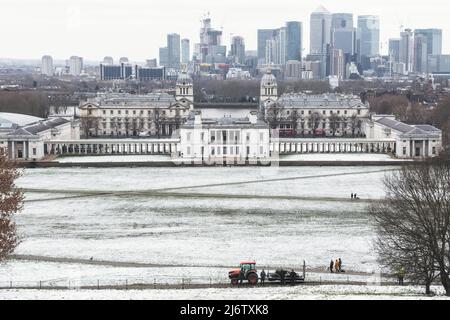 London, UK - March 19, 2022 - View of Queens House and Canary Wharf from Greenwich Park in winter snow Stock Photo