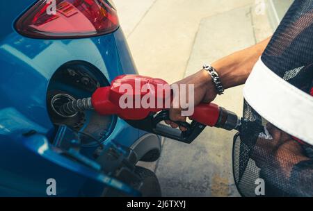 Car fueling at gas station. Refuel fill up with petrol gasoline. Petrol pump filling fuel nozzle in fuel tank of car at gas station. Petrol industry Stock Photo