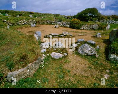 Looking NE from inside House III to the courtyard & entrance (rear R) of House II at Carn Euny ancient village, West Penwith, Cornwall, England, UK. Stock Photo