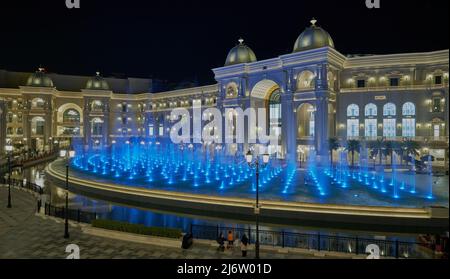 Place Vendome Mall  in Lusail city, Qatar interior view at night showing the architecture of the mall with big fountain in foreground Stock Photo