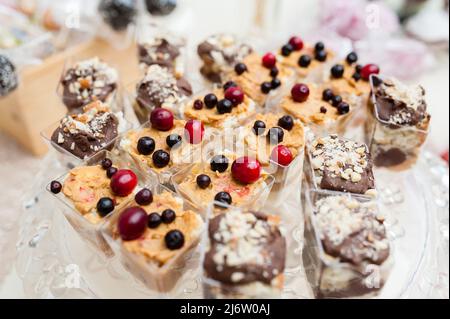 Multi-colored cakes and sweets on the festive table. Stock Photo